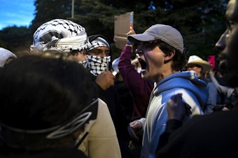 caption: Following a talk by Turning Point USA founder Charlie Kirk, supporters clashed with University of Washington students and protesters who barricaded the east entrance to the encampment for Palestine on the Quad on Tuesday, May 7, 2024, in Seattle. 