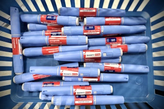 caption: Several Ozempic pens in a basket
