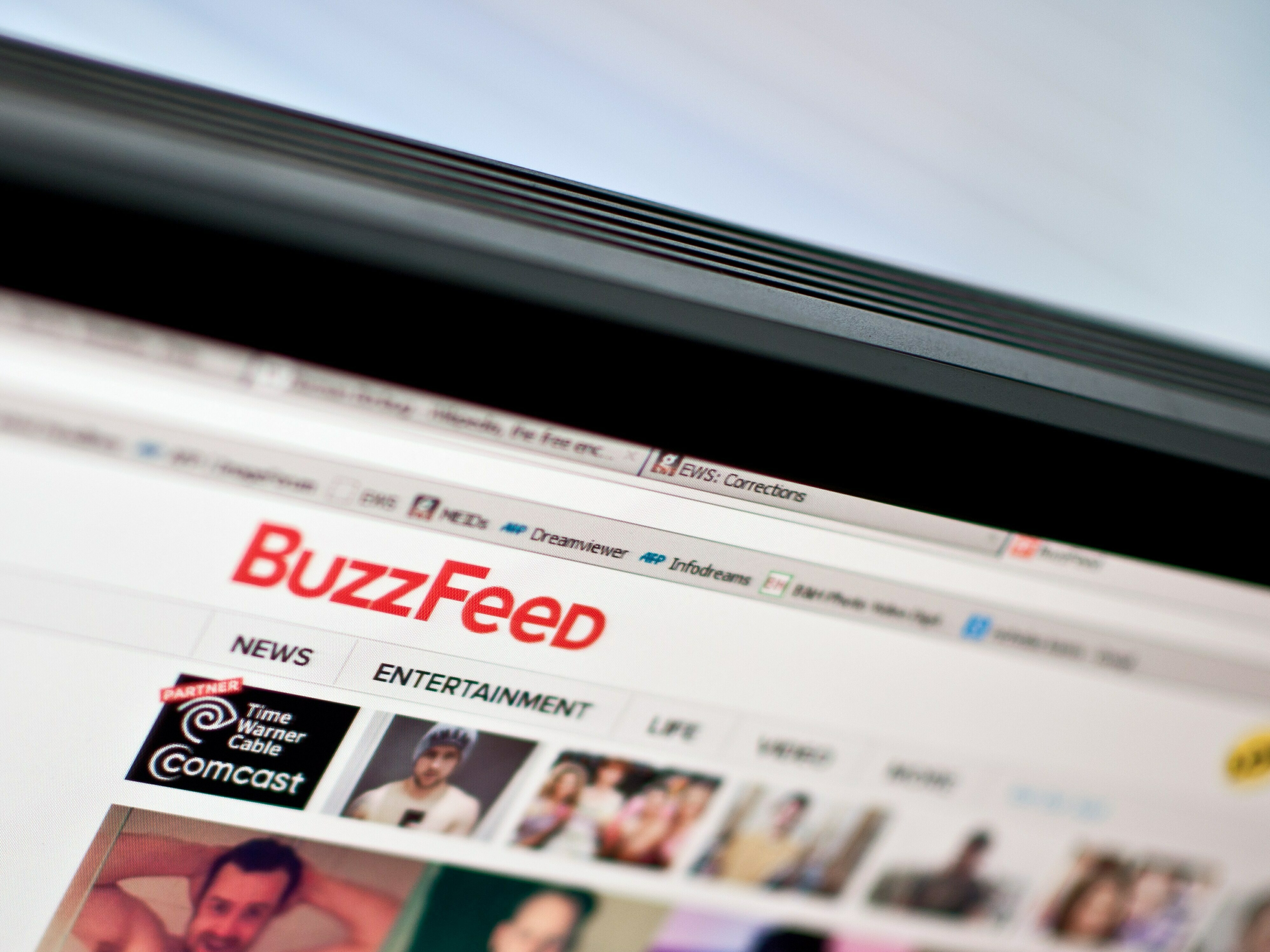 caption: The logo of news website BuzzFeed in 2014. The company announced it was undergoing a 15% reduction in force and ending its news division.