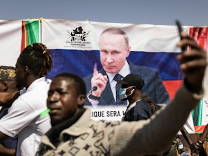 caption: A banner of Russian President Vladimir Putin is seen during a protest to support the Burkina Faso President Captain Ibrahim Traore and to demand the departure of France's ambassador and military forces, in Ouagadougou, on Jan. 20, 2023. Russia has been trying to expand its influence throughout Africa in recent years.