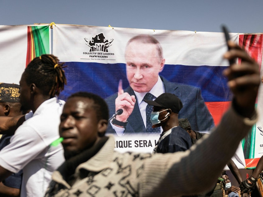 caption: A banner of Russian President Vladimir Putin is seen during a protest to support the Burkina Faso President Captain Ibrahim Traore and to demand the departure of France's ambassador and military forces, in Ouagadougou, on Jan. 20, 2023. Russia has been trying to expand its influence throughout Africa in recent years.
