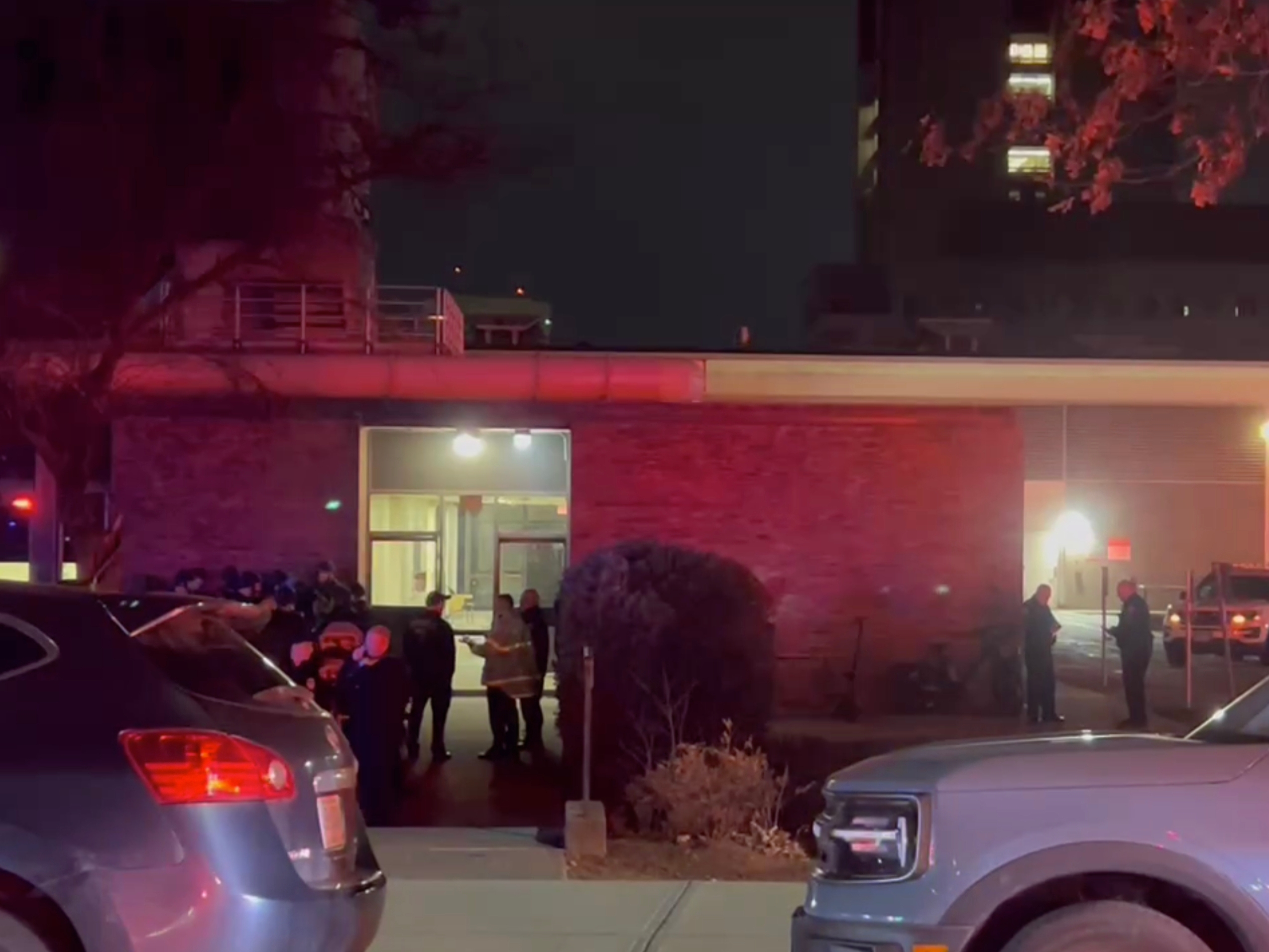 caption: In this image from video, law enforcement officials gather outside the Brown University campus in Providence, R.I., on Saturday, Dec. 13, 2025.