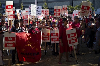 caption: Seattle Public Schools teachers rally ahead of the first day of school on Tuesday, September 6, 2022, outside of Seattle Public School's offices along 3rd Avenue South in Seattle.