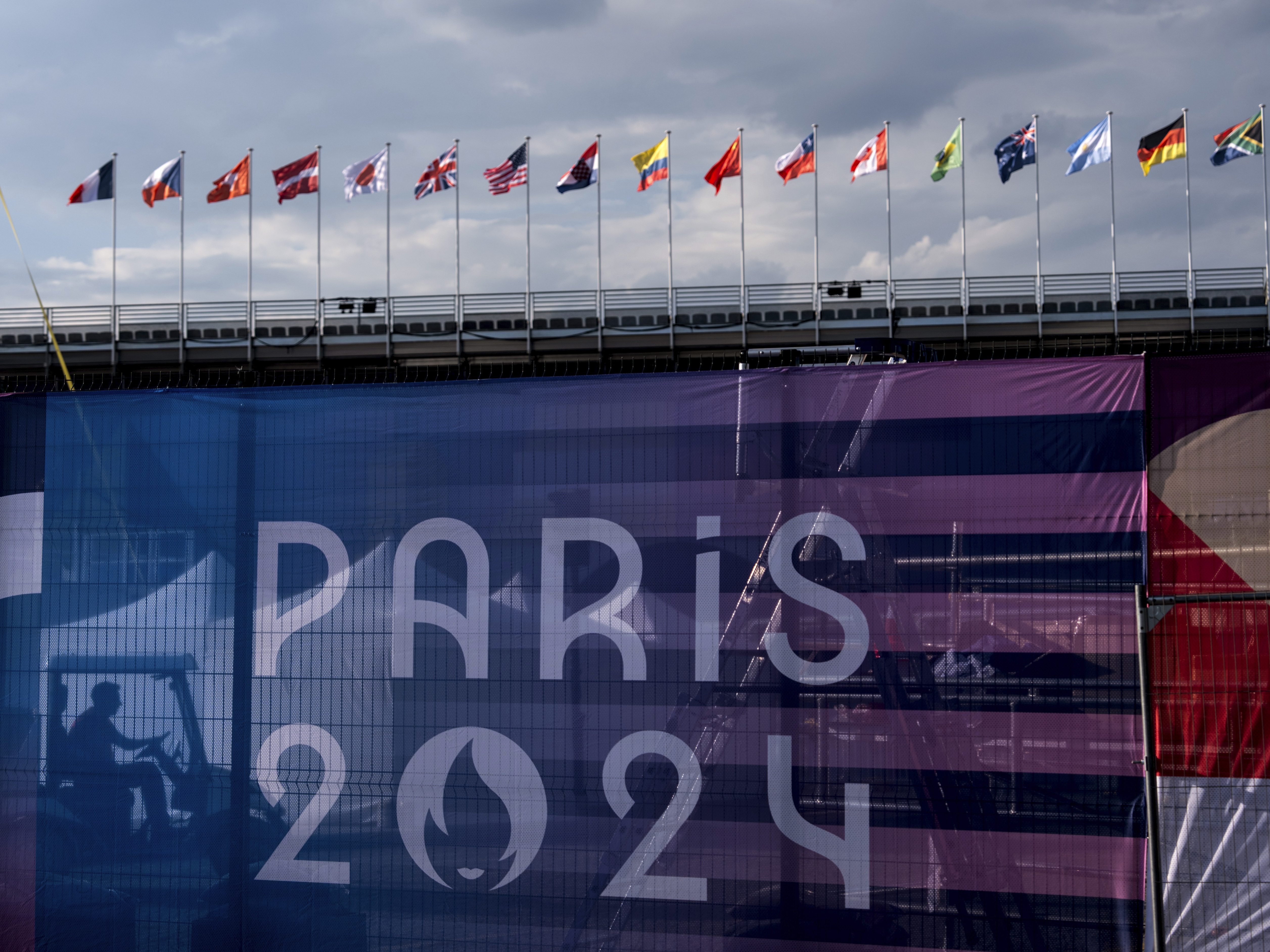 caption: A worker drives a golf cart inside the competition venue for BMX freestyle ahead of the 2024 Summer Olympics, Friday, July 19, 2024, in Paris. (AP Photo/David Goldman)