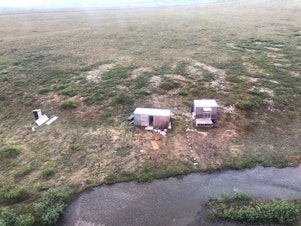caption: Pictured is a remote mining camp near Nome, Alaska, where a Coast Guard Air Station Kodiak aircrew rescued the survivor of a bear attack on July 16.