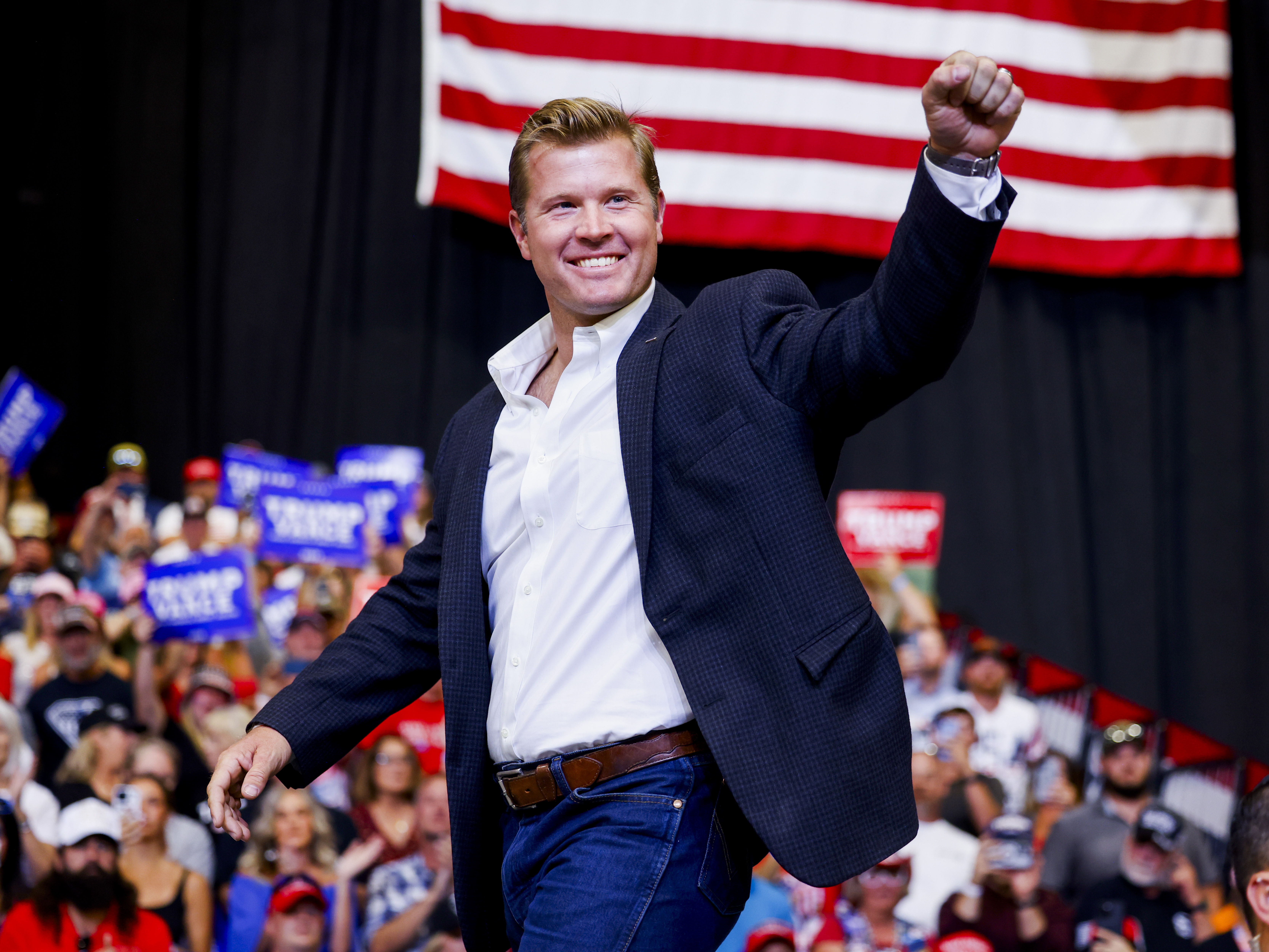 caption: Montana Republican Tim Sheehy on stage during a rally for Trump on Aug. 9.
