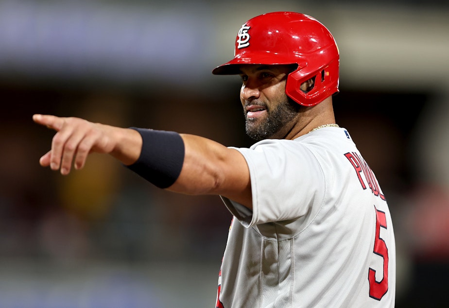 caption: Albert Pujols of the St. Louis Cardinals points to the San Diego Padres dugout after hitting a single during the ninth inning of Monday night's game in San Diego. He ended the night with two singles, a walk and no home runs.