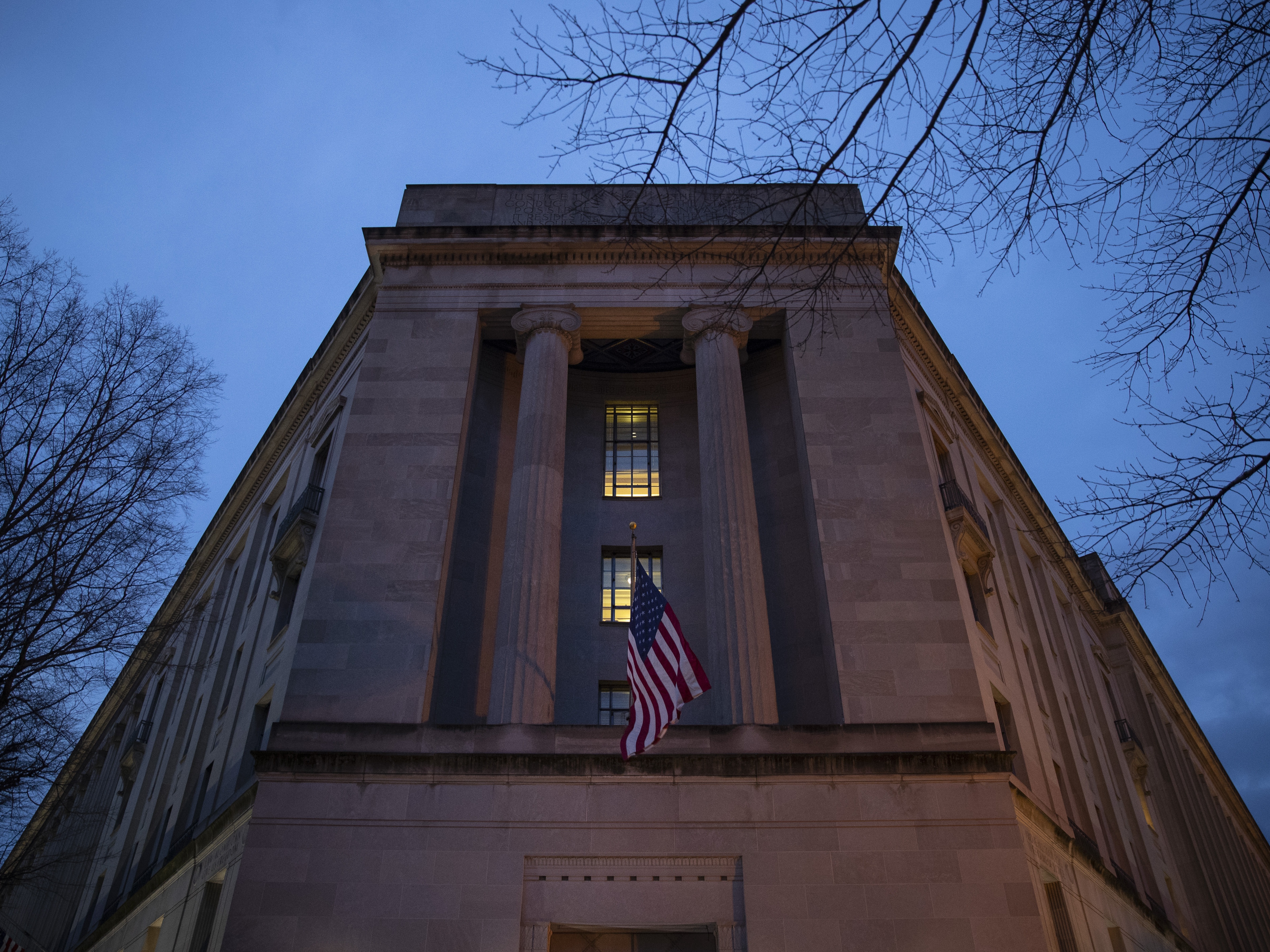 caption: The Department of Justice stands in the early morning hours in 2019 in Washington, D.C.