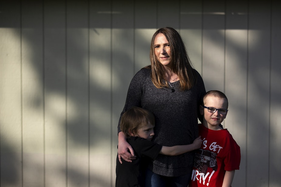 caption: Amanda Schroeder, 31, stands with her two sons Jayden, 6, left, and Jeremiah, 8, on Tuesday, April 25, 2023, at Erickson Park in Port Angeles.