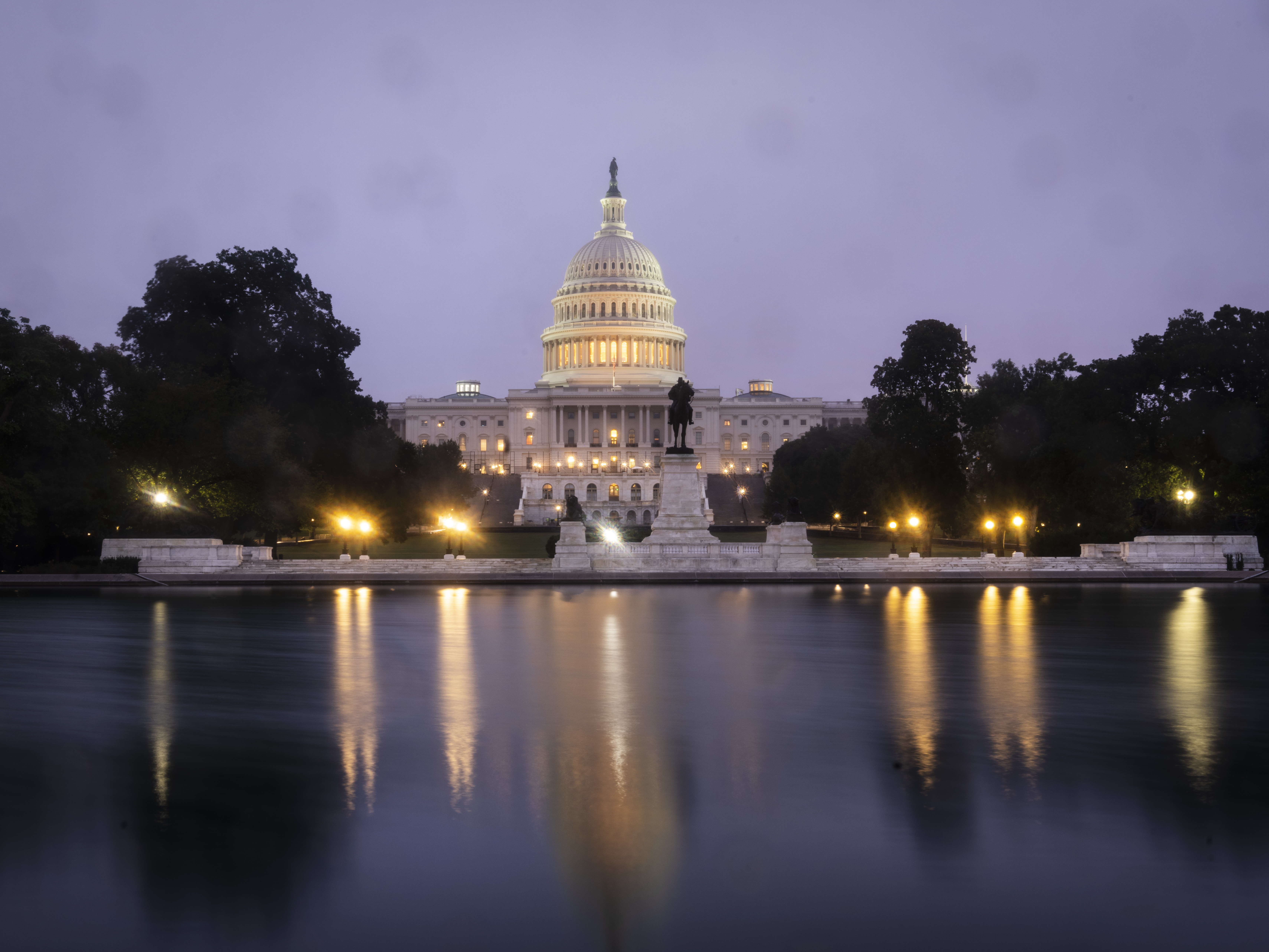 caption: A view of the U.S. Capitol at dawn Oct. 6.