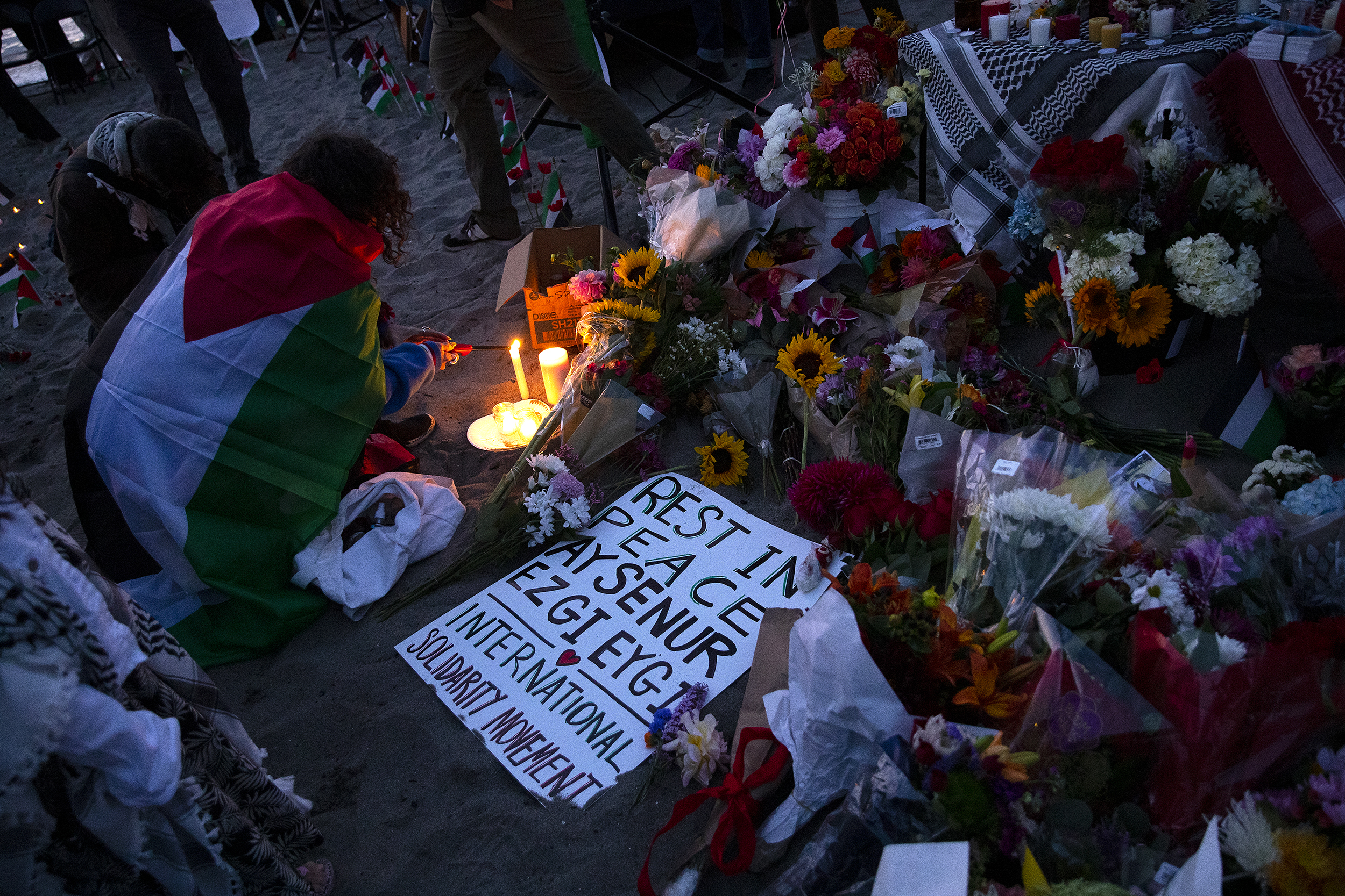 caption: Candles are lit as hundreds gathered for a vigil in honor of Aysenur Ezgi Eygi, a 26-year-old Turkish American activist who was killed by Israeli soldiers while participating in an anti-settlement protest in the occupied West Bank, on Wednesday, September 11, 2024, at Alki Beach Park in Seattle. 