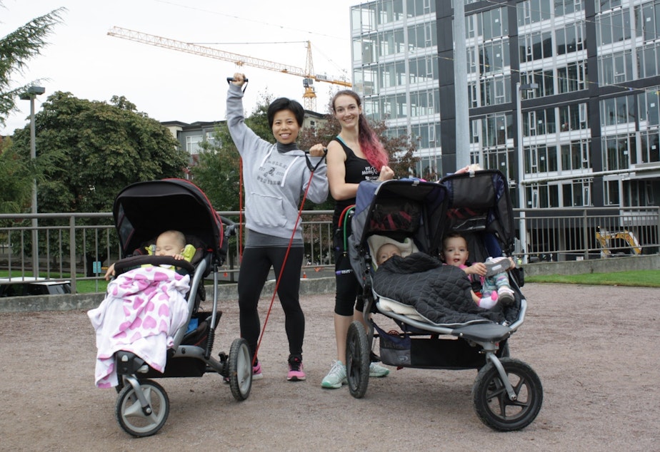 caption: Yu Deng and her coworker lead moms in exercise at Bellevue's Downtown Park.