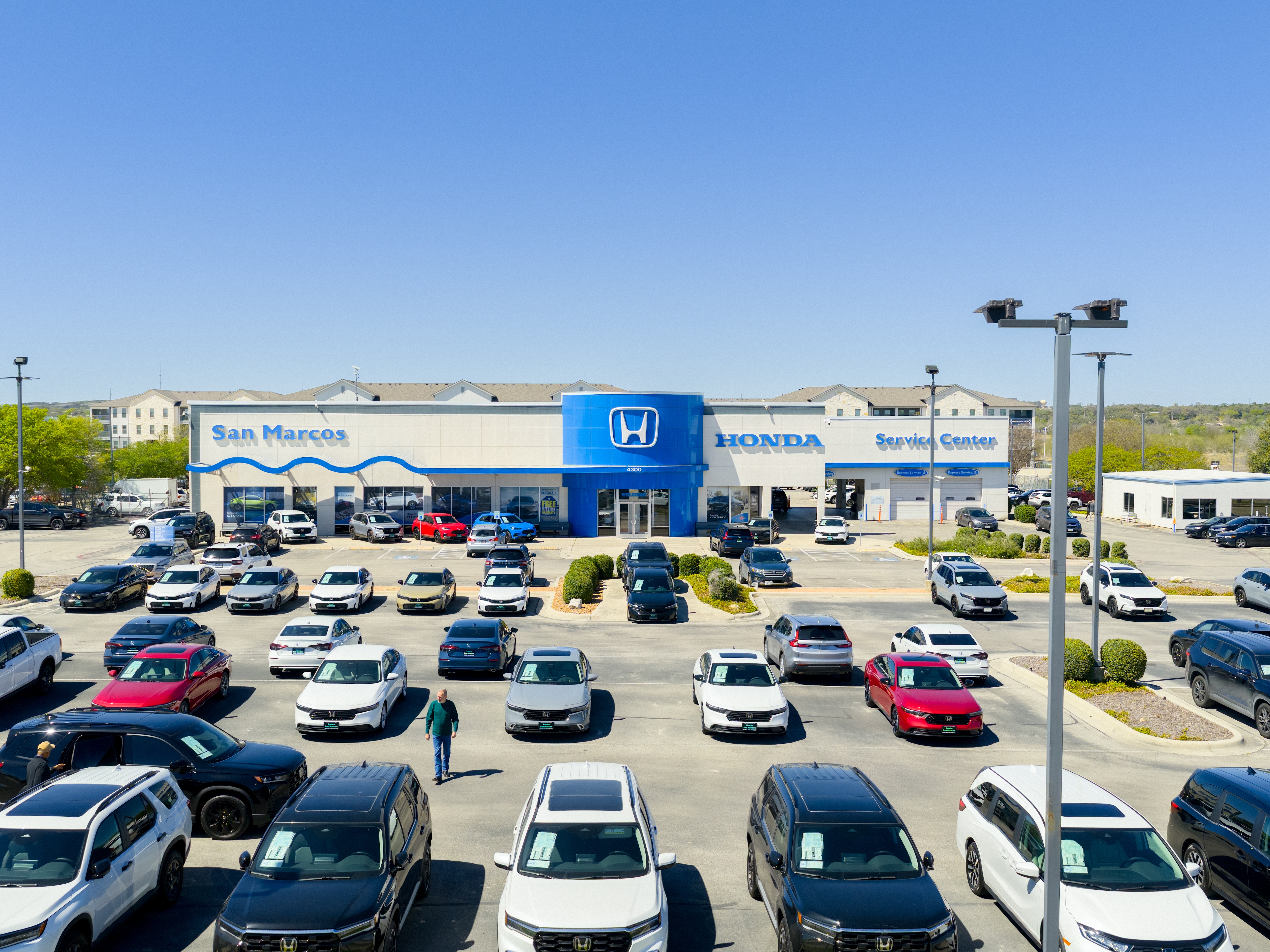 caption: Vehicles fill the parking lot at a Honda dealership in San Marcos, Texas. About 60% of the Honda vehicles sold in the U.S. last year were assembled in the United States, according to Honda, which means they could be eligible for a new tax provision allowing buyers to deduct the interest paid on their auto loans.