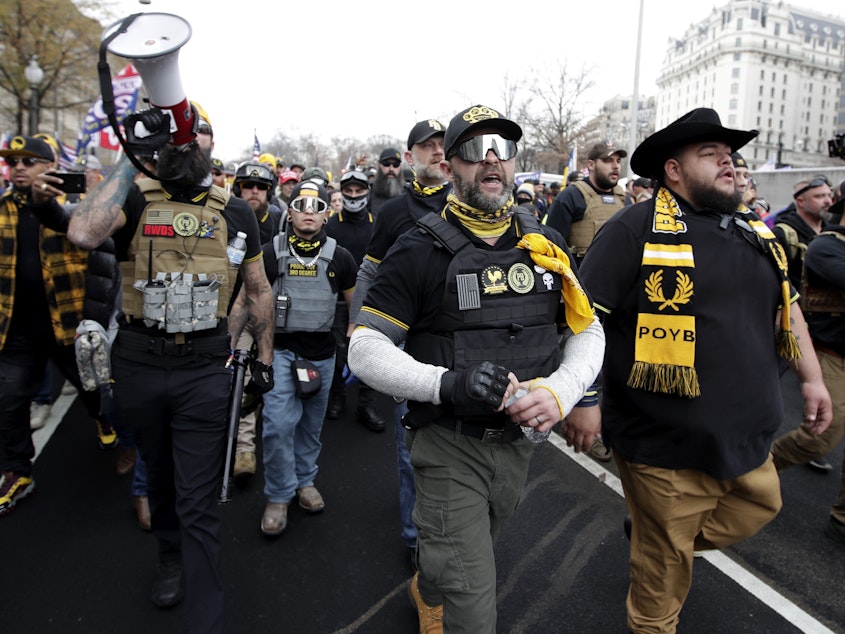 caption: Demonstrators wearing clothes linked to the far-right extremist group  Proud Boys attend a pro-Trump rally in Washington last month.