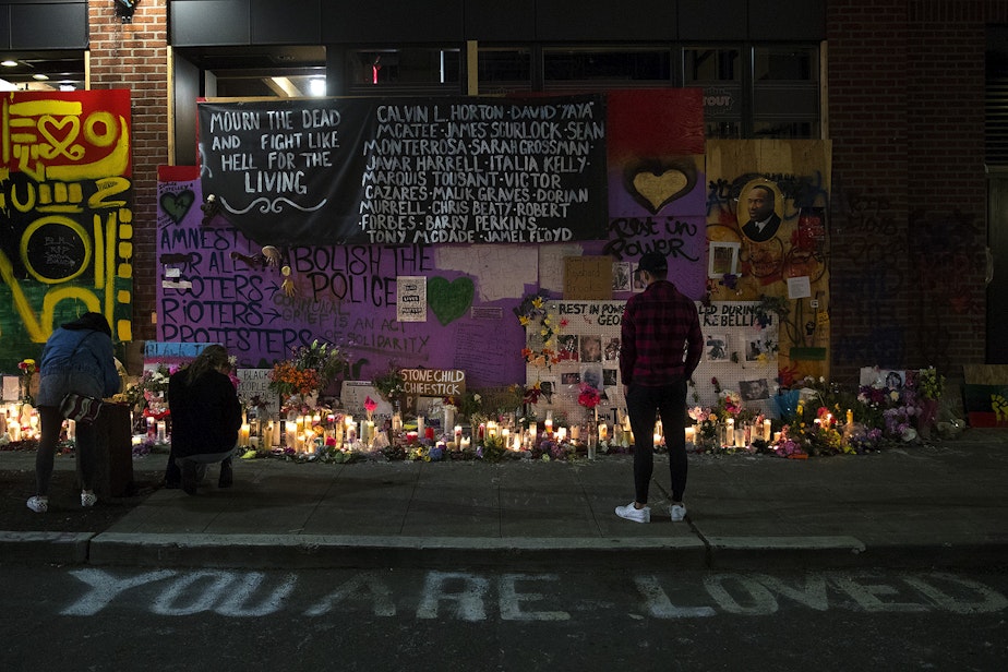 caption: A growing vigil with candles, flowers, artwork and the names of Black Americans unjustly killed at the hands of law enforcement is shown on Saturday, June 13, 2020, in the Capitol Hill Autonomous Zone, CHAZ, or Capitol Hill Occupied Protest, CHOP, in Seattle.