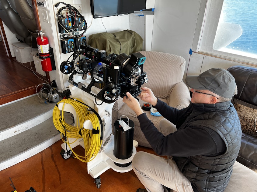 caption: Jeff Hummel readies the remote operated vehicle ahead of his trip to the center of Elliott Bay.