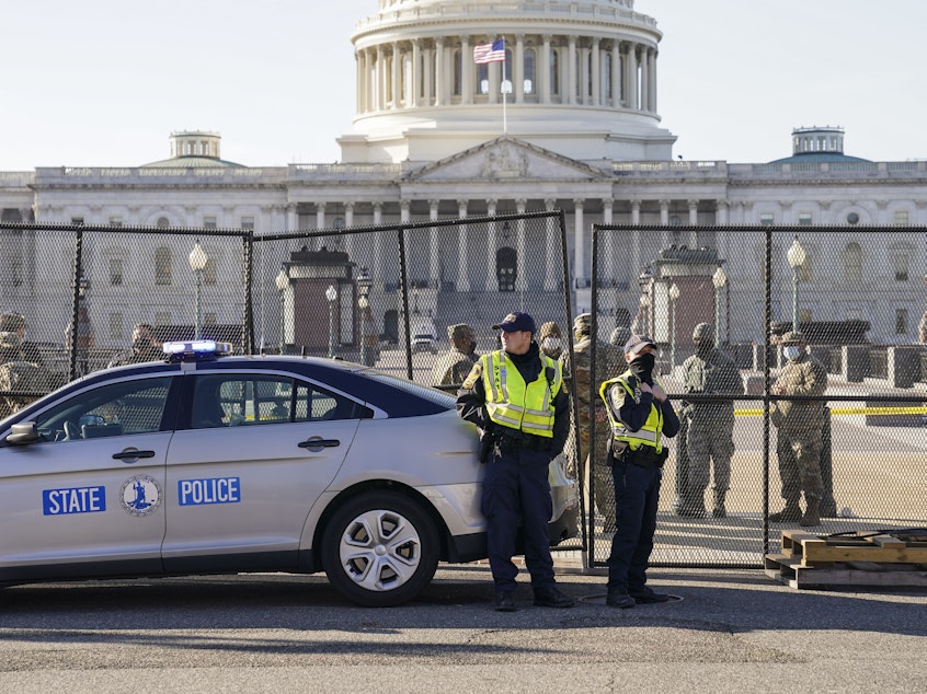 caption: Fencing is placed around the exterior of the Capitol grounds on Thursday, the day after pro-Trump rioters stormed the building. Lawmakers from both parties have criticized the U.S. Capitol Police's response to the security breach.