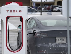 caption: Tesla owners in Chicago say the intense cold is making it difficult to charge their vehicles. Here, a Tesla is seen at a Supercharger in Rolling Meadows, Ill., last January.