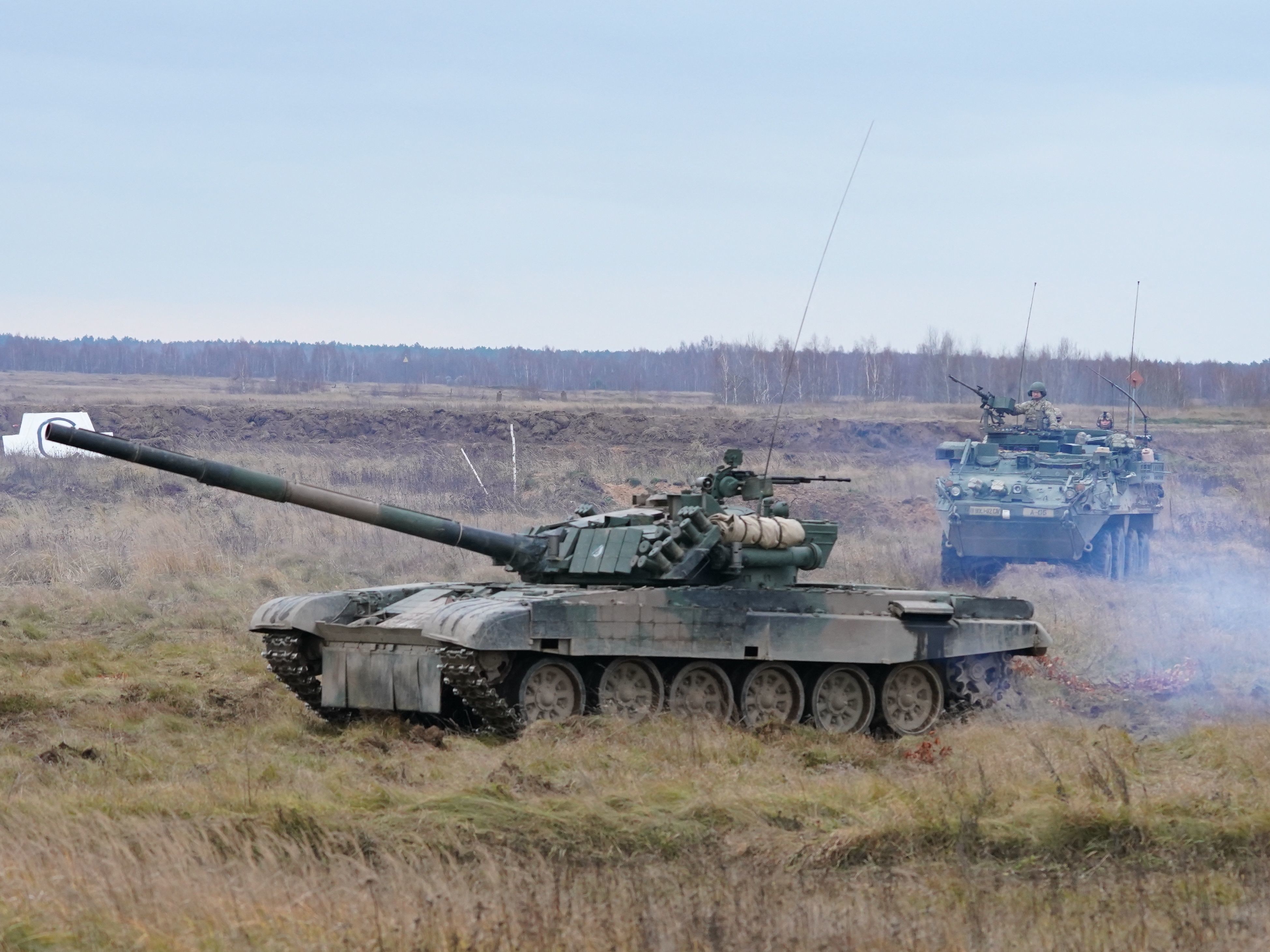 caption: Soldiers of Poland, Britain, the United States and Romania take part in military exercises at the military training ground in Bemowo Piskie, Poland, on Nov. 18, 2021.
