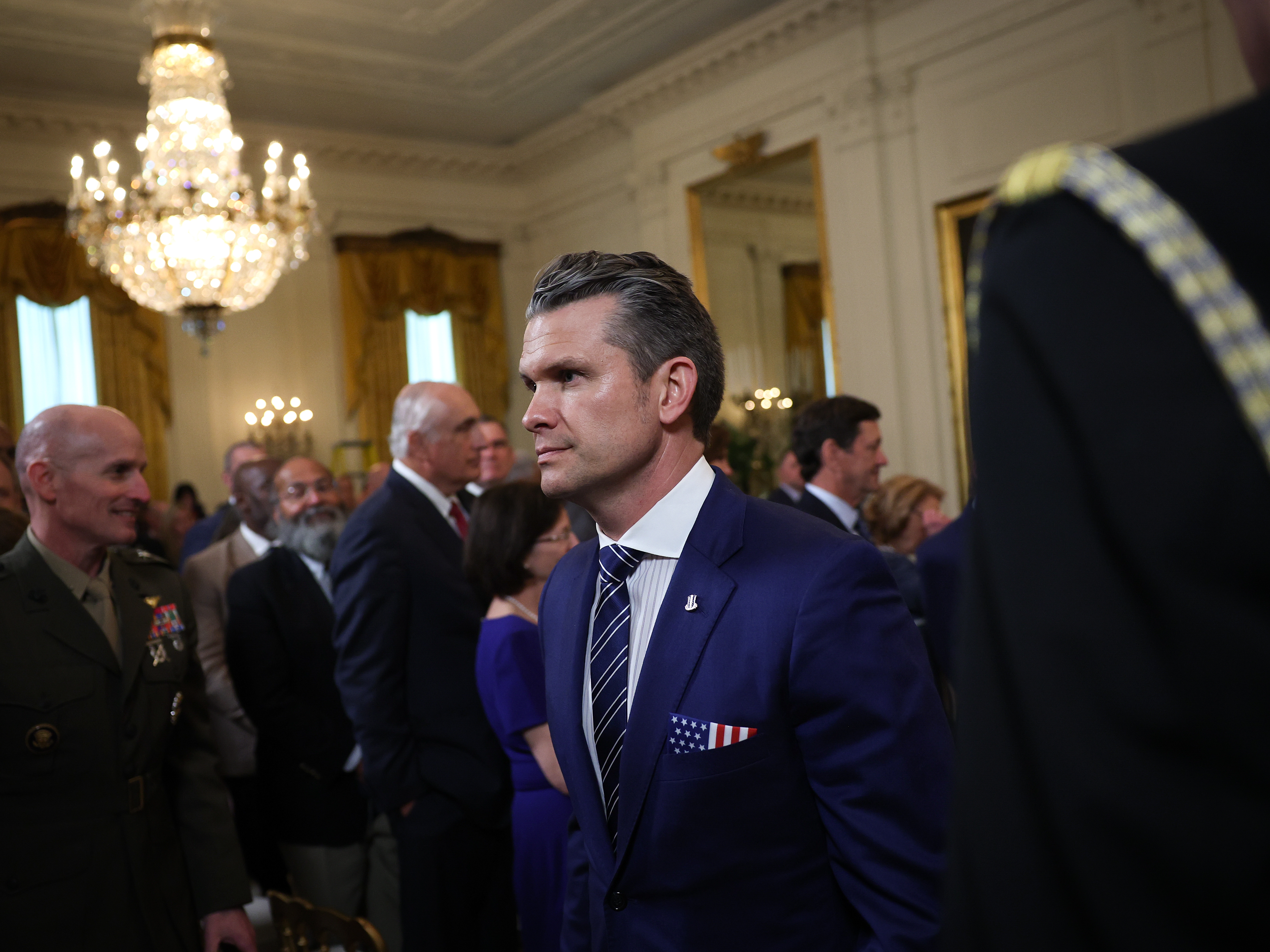caption: Secretary of Defense Pete Hegseth departs a presentation ceremony for the Commander-in-Chief Trophy to the U.S. Naval Academy Midshipmen football team in the East Room of the White House on April 15.