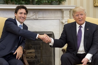 caption: President Trump and Canadian Prime Minister Justin Trudeau shake hands during a meeting in the Oval Office in February.