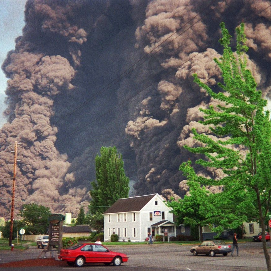 caption: A cloud of smoke rises high in the air following an explosion at Whatcom Creek on June 10, 1999.