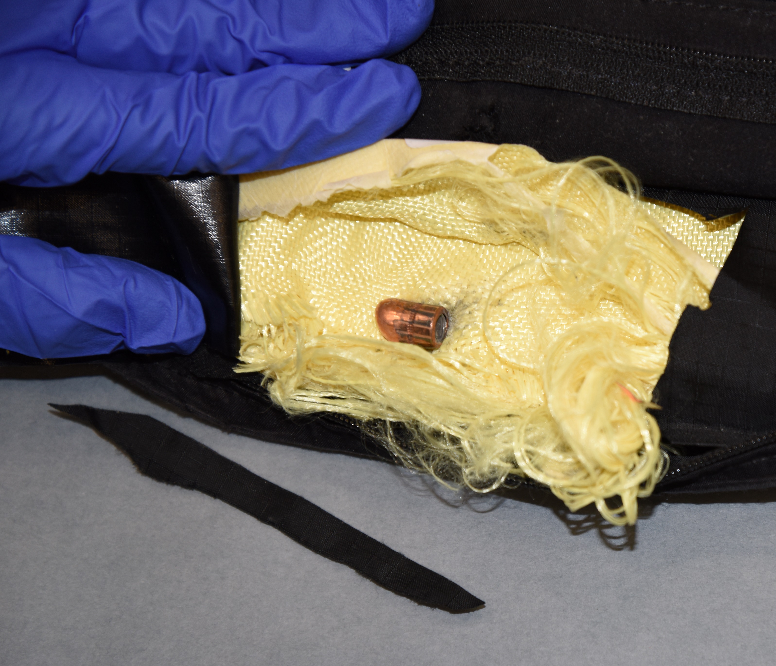 caption: A bullet fired at a Seattle police officer is removed from her bulletproof vest.