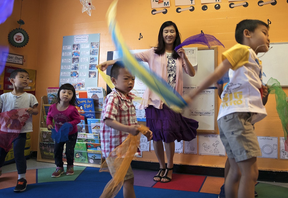 caption: Seattle Preschool Program teacher Hien Do, center, dances with her students on Wednesday, June 28, 2017, at the ReWA Early Learning Center at Beacon, in Seattle, Washington. The center is currently closed due to Covid-19.