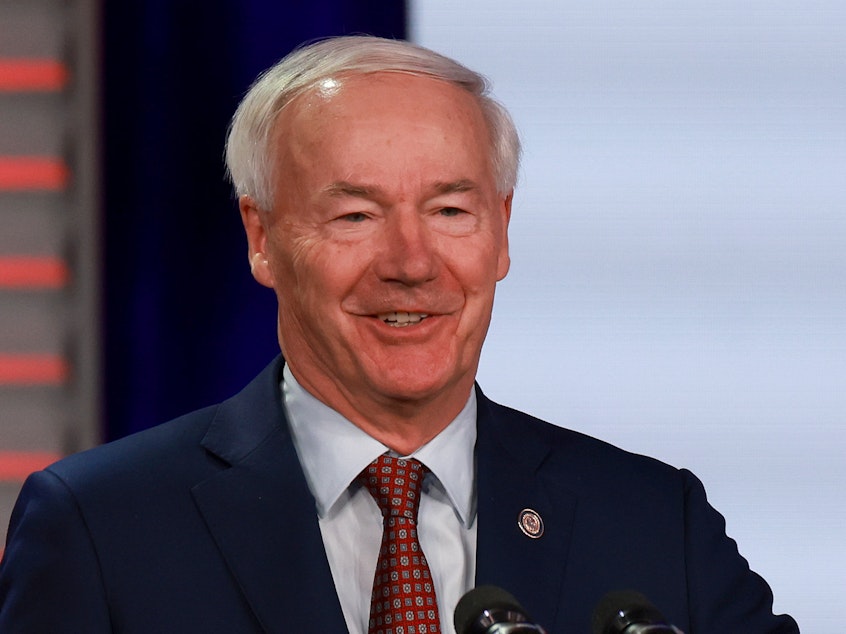 caption: Former Arkansas Governor Asa Hutchinson speaks during the Florida Freedom Summit held at the Gaylord Palms Resort on Nov. 4, 2023 in Kissimmee, Florida.