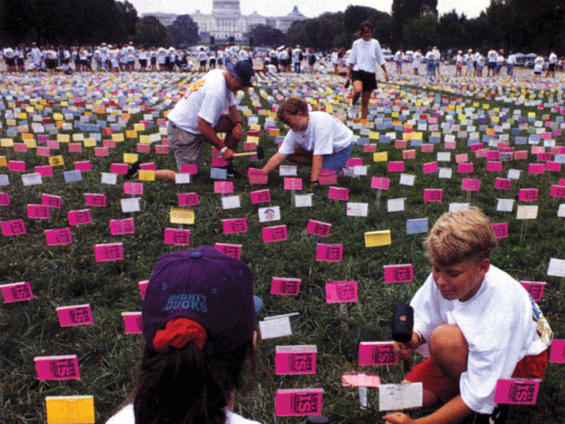 caption: In 1994, young people wearing "True Love Waits" T-shirts hammer pledge cards stating they'll abstain from sex until marriage into the lawn of the National Mall in Washington, D.C.
