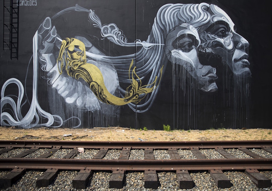 caption: A mural painted by artist Caratoes is shown on Tuesday, August 15, 2017, along the Sodo Track in Seattle. 
