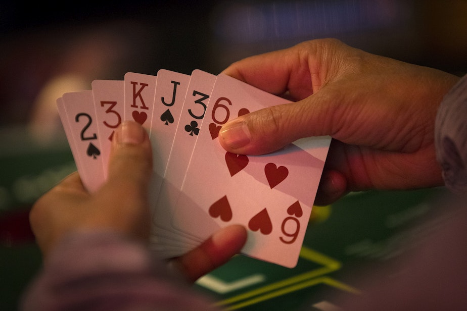 caption: Patrons play pai gow poker on Tuesday, May 17, 2022, at the Great American Casino in Tukwila.