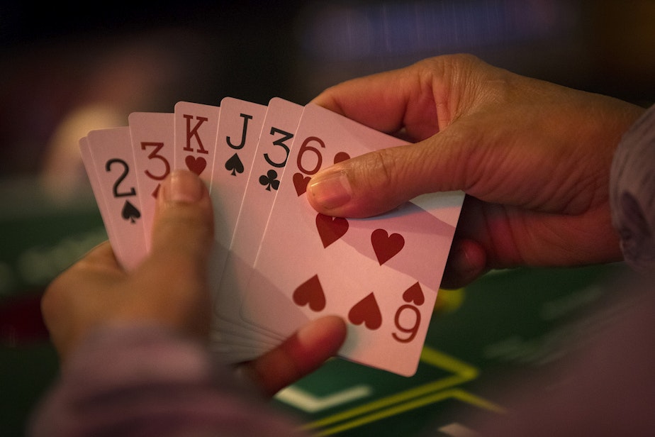 caption: Patrons play pai gow poker on Tuesday, May 17, 2022, at the Great American Casino in Tukwila. 