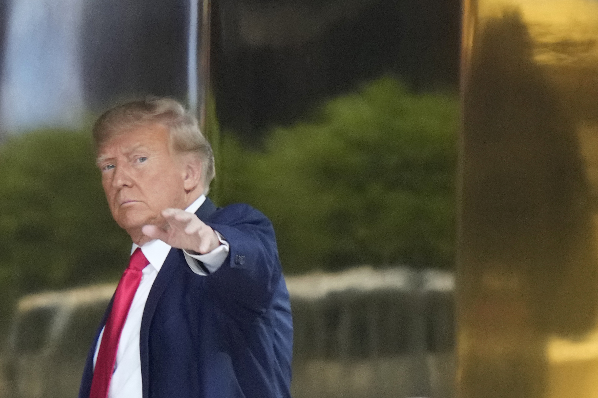 caption: Former president Donald Trump arrives at Trump Tower in New York on Monday, April 3, 2023. Trump is expected to be booked and arraigned on Tuesday on charges arising from hush money payments during his 2016 campaign. 
