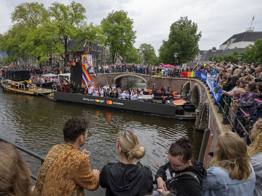 caption: Tens of thousands of people watched as dozens of colorfully decorated boats toured the Dutch capital's historic canals Saturday, Aug. 5, 2023, in the most popular event of a six-day Pride Amsterdam festival that attracts tens of thousands of visitors to the city.