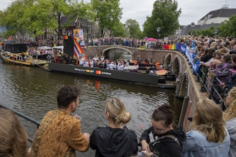 caption: Tens of thousands of people watched as dozens of colorfully decorated boats toured the Dutch capital's historic canals Saturday, Aug. 5, 2023, in the most popular event of a six-day Pride Amsterdam festival that attracts tens of thousands of visitors to the city.