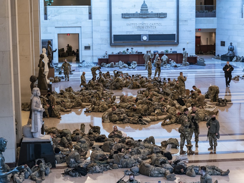 caption: Hundreds of National Guard troops hold inside the Capitol Visitor's Center to reinforce security at the Capitol in Washington.