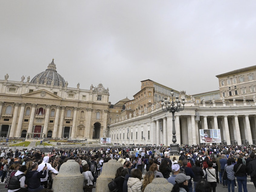 caption: The crowd looks in direction of the window of the apostolic palace overlooking St. Peter's square during Pope Francis' prayer on April 1 in The Vatican.
