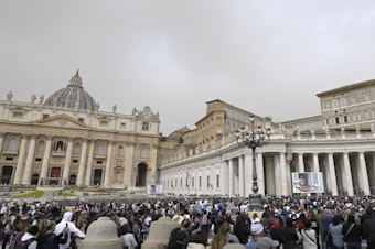 caption: The crowd looks in direction of the window of the apostolic palace overlooking St. Peter's square during Pope Francis' prayer on April 1 in The Vatican.