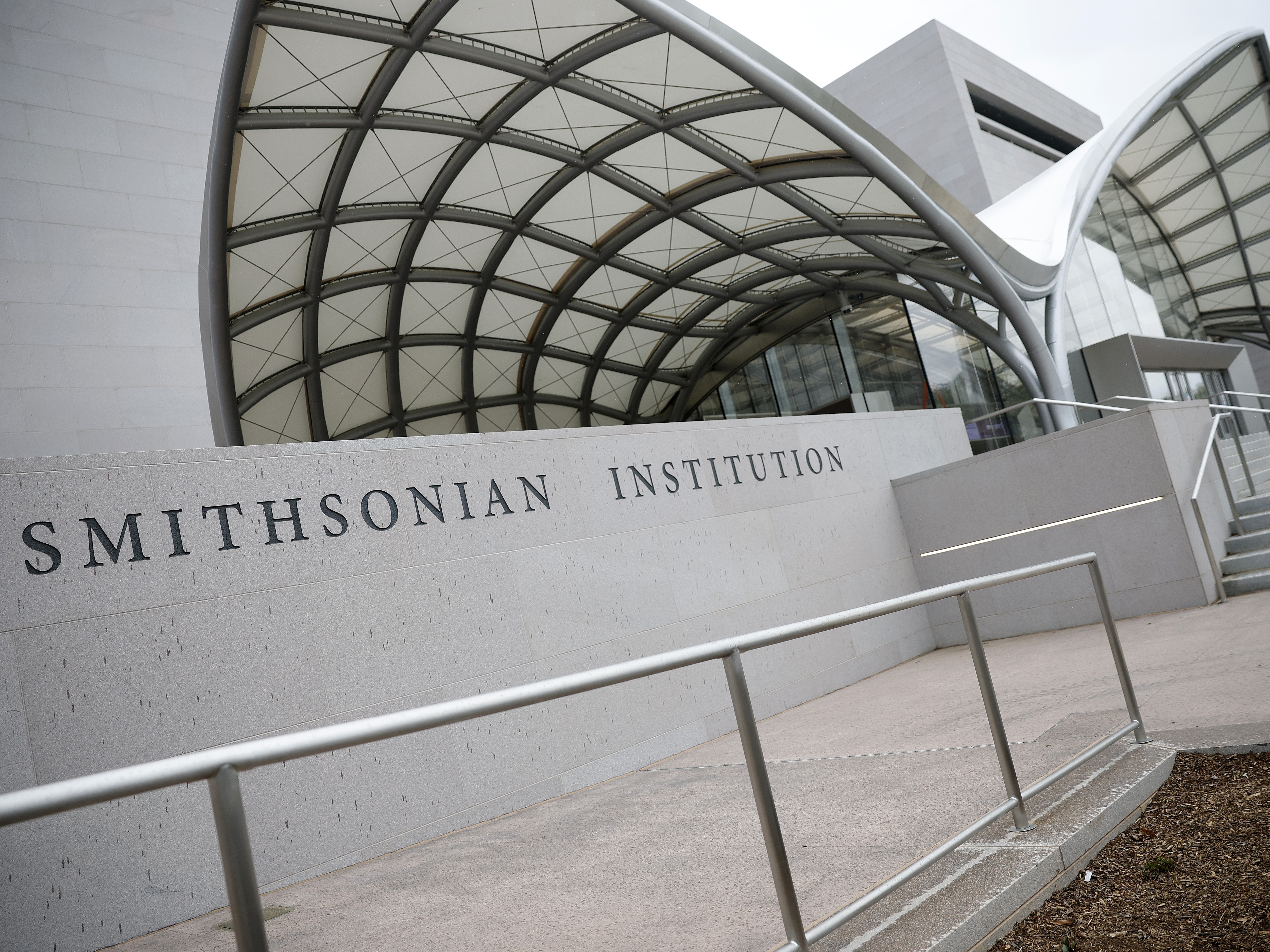 caption: A Smithsonian Institution sign is seen on the National Air and Space Museum on the National Mall  in Washington, DC.