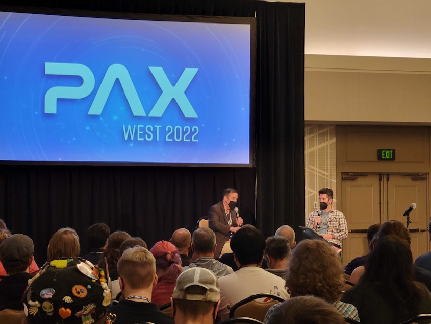 caption: Washington Secretary of State Steve Hobbs speaks in front of a crowd at PAX West - a gaming convention in Seattle.