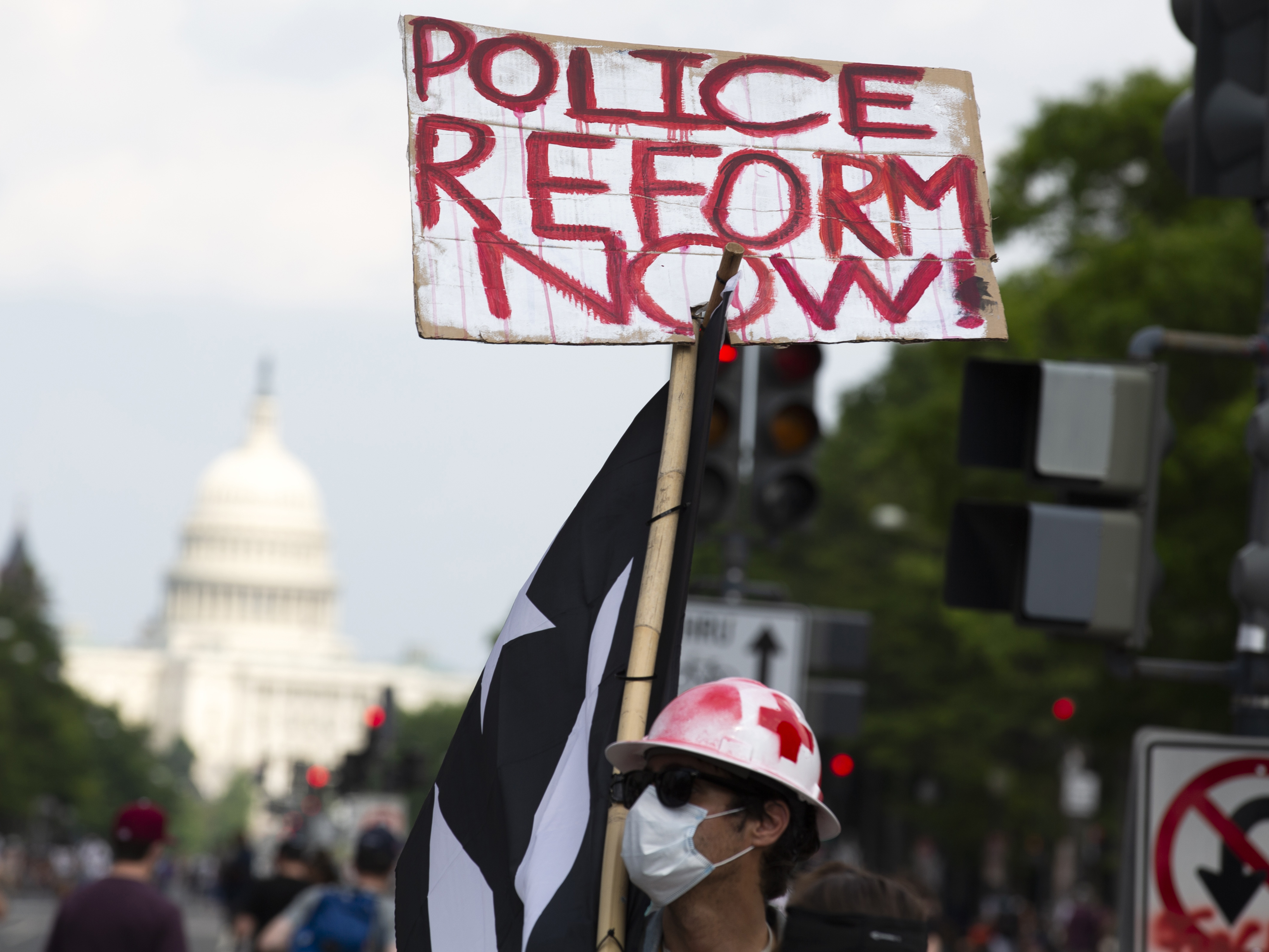 caption: A demonstrator holds a placard during a march against racism and police brutality in Washington, D.C., on Saturday. Congressional Democrats have released a wide-ranging proposal aimed at overhauling policing