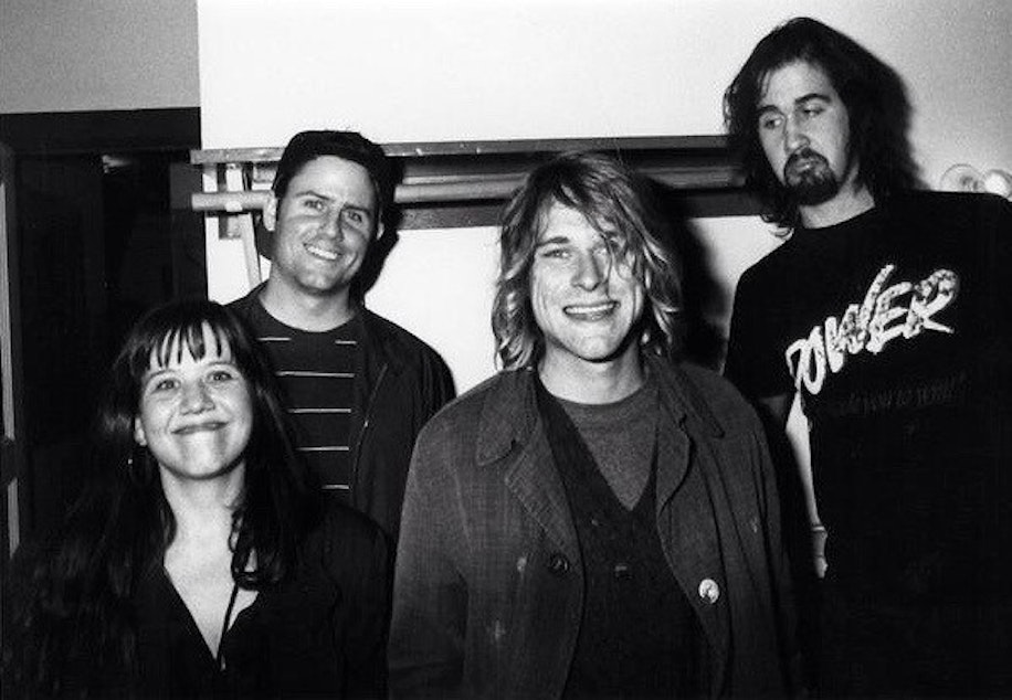 caption: Susie Tennant, lower left, Seattle radio DJ Marco Collins, second from left, with Kurt Cobain and Krist Novoselic of Nirvana  when Nevermind was released.