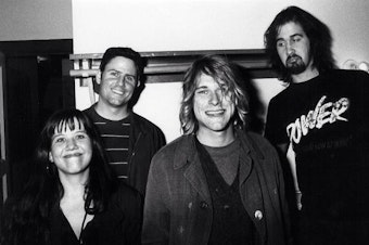caption: Susie Tennant, lower left, Seattle radio DJ Marco Collins, second from left, with Kurt Cobain and Krist Novoselic of Nirvana  when Nevermind was released.