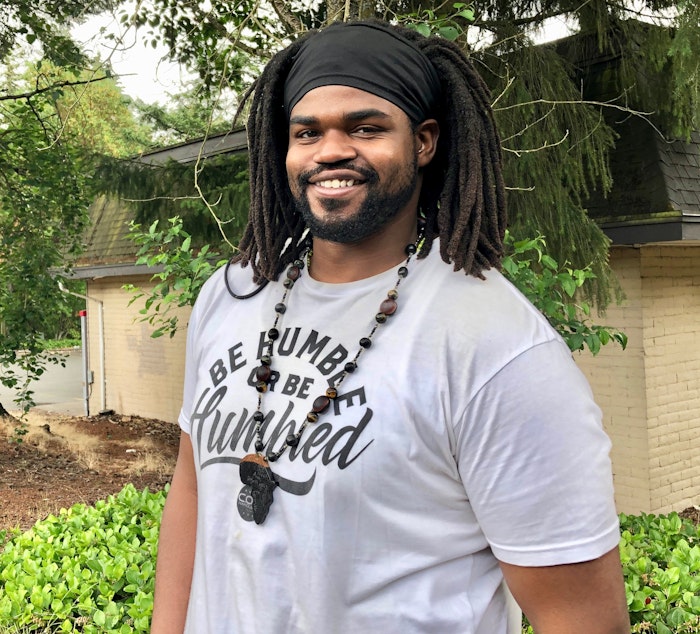 caption: Evan Cook stands for a portrait on Wednesday, July 1, 2020.