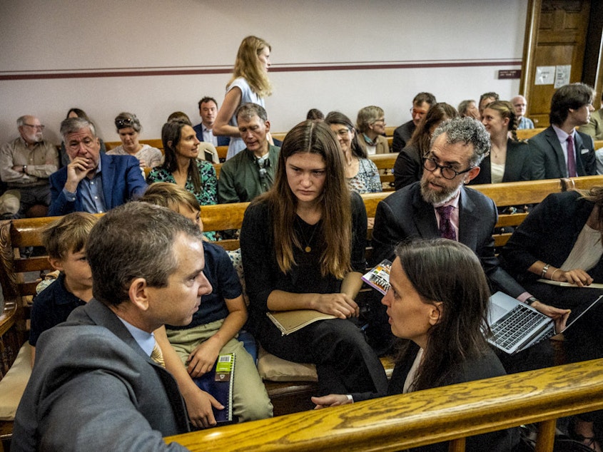 caption: Lead claimant Rikki Held, 22, confers with members of Our Children's Trust legal team before the start of the nation's first youth climate change trial at Montana's First Judicial District Court on June 12, 2023 in Helena, Montana.