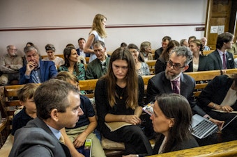 caption: Lead claimant Rikki Held, 22, confers with members of Our Children's Trust legal team before the start of the nation's first youth climate change trial at Montana's First Judicial District Court on June 12, 2023 in Helena, Montana.