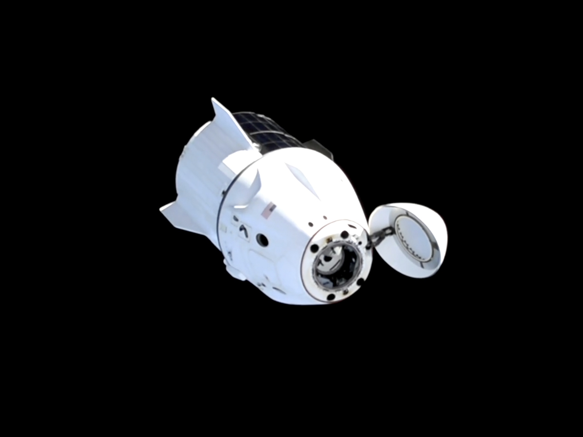 caption: This image taken from NASA video shows the SpaceX capsule carrying NASA astronauts Suni Williams, Butch Wilmore and Nick Hague as well as Russian cosmonaut Aleksandr Gorbunov after it undocked from the International Space Station on Tuesday.