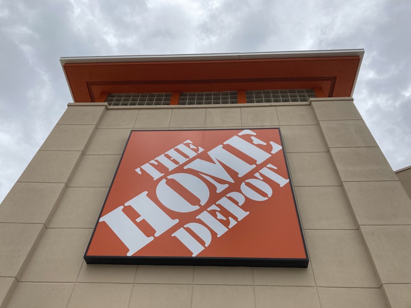 caption: A Home Depot logo sign hands on its facade, Friday, May 14, 2021, in North Miami, Fla.
