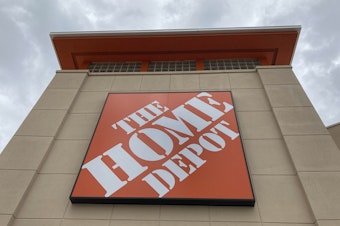 caption: A Home Depot logo sign hands on its facade, Friday, May 14, 2021, in North Miami, Fla.